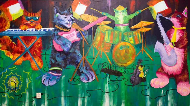Målning av katter som spelar i band