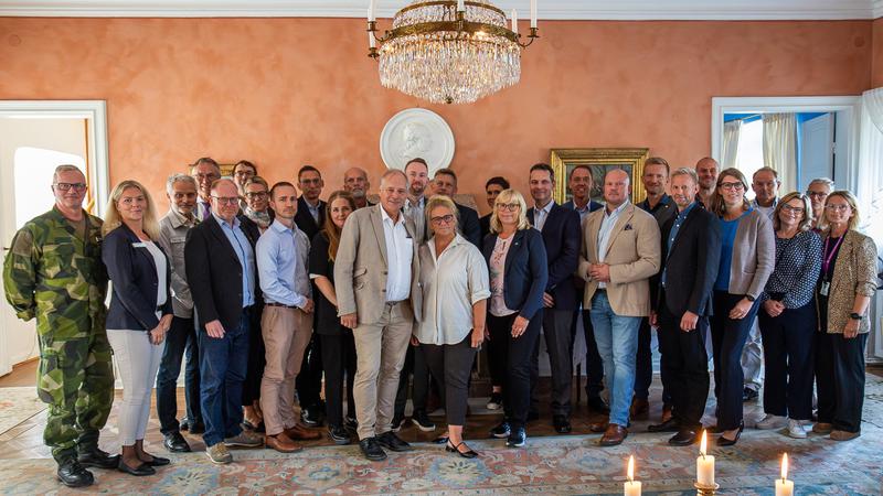 Foto David Skoog. Gaist bildas. En grupp människor som står bredvid varandra i ett rum