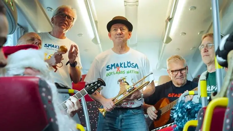 Ett gäng musiker uppträder med instrument i en buss