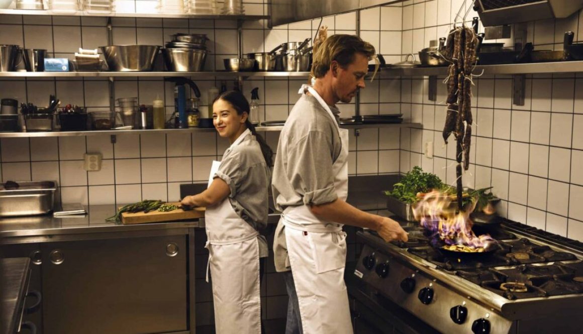 kvinna och man lagar mat i restaurangkök