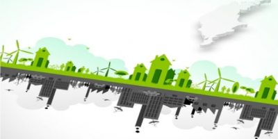 Två olika illustrerade städer. En grön med vindkraftverk och en grå med utsläpp.